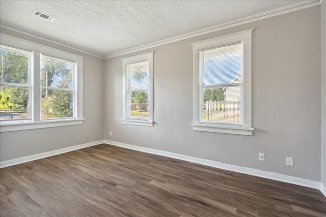 unfurnished room featuring dark wood-type flooring, a textured ceiling, and ornamental molding