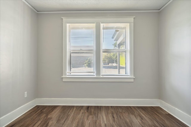 unfurnished room with ornamental molding and dark hardwood / wood-style flooring