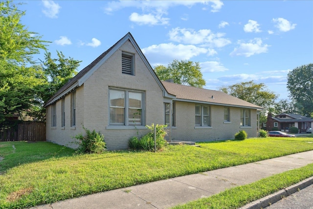 view of side of home with a lawn