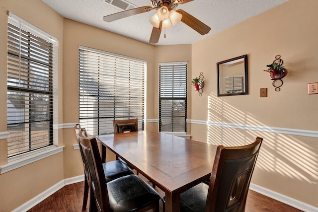 dining room with ceiling fan, a textured ceiling, and dark hardwood / wood-style flooring