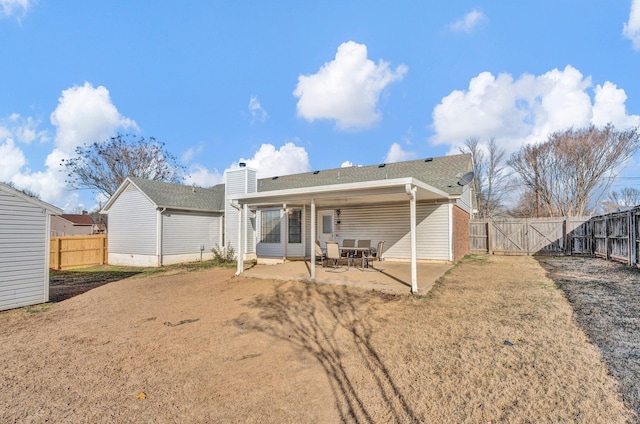 back of house featuring a yard and a patio