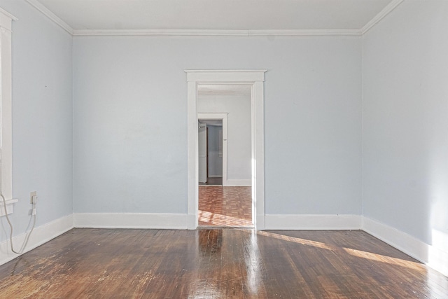 unfurnished room with dark wood-type flooring and ornamental molding