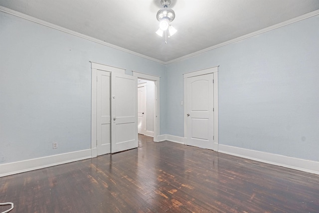 spare room featuring ornamental molding and dark hardwood / wood-style flooring