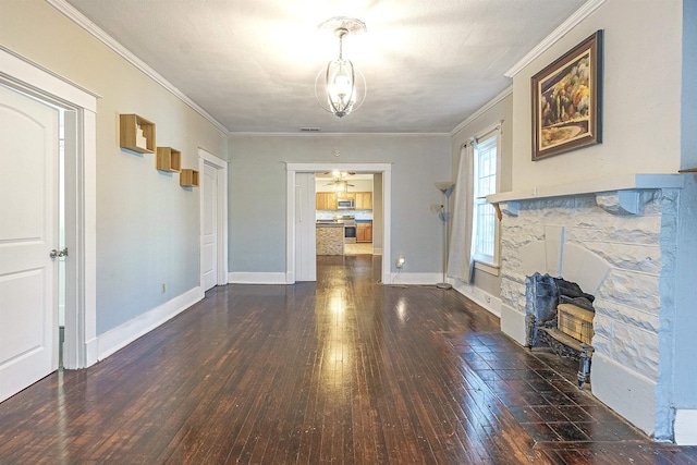 living room with dark hardwood / wood-style floors, crown molding, and a stone fireplace