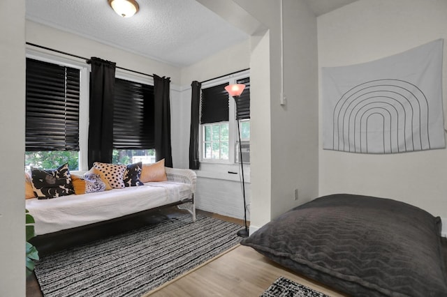 bedroom featuring a textured ceiling and hardwood / wood-style floors