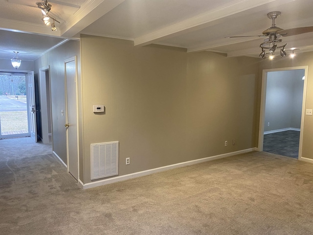 spare room with ceiling fan, carpet floors, and beamed ceiling