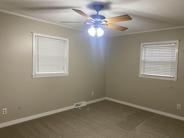 empty room featuring ceiling fan, ornamental molding, a textured ceiling, and carpet flooring