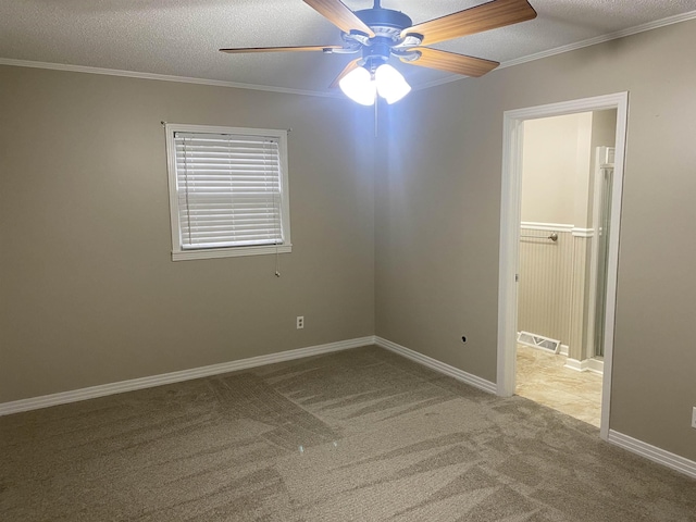 unfurnished room featuring ceiling fan, light colored carpet, a textured ceiling, and ornamental molding