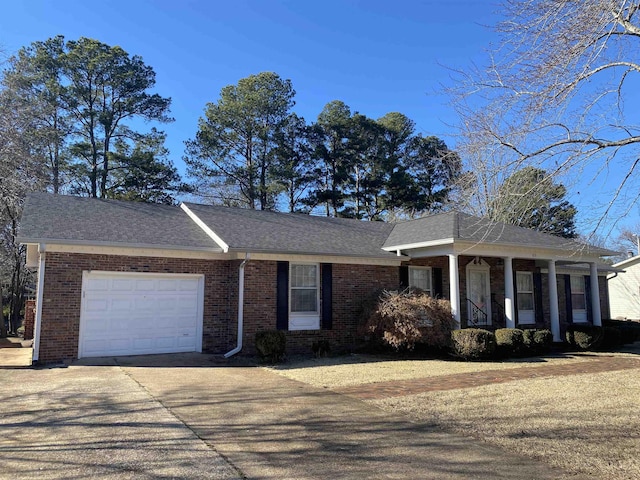 ranch-style home with a garage and covered porch