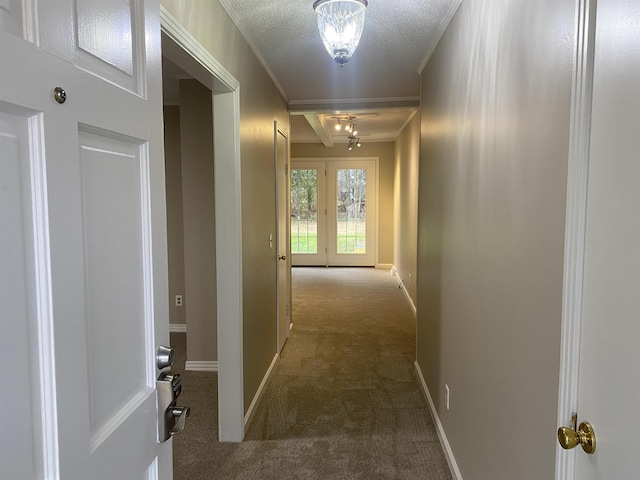 corridor with a textured ceiling and carpet