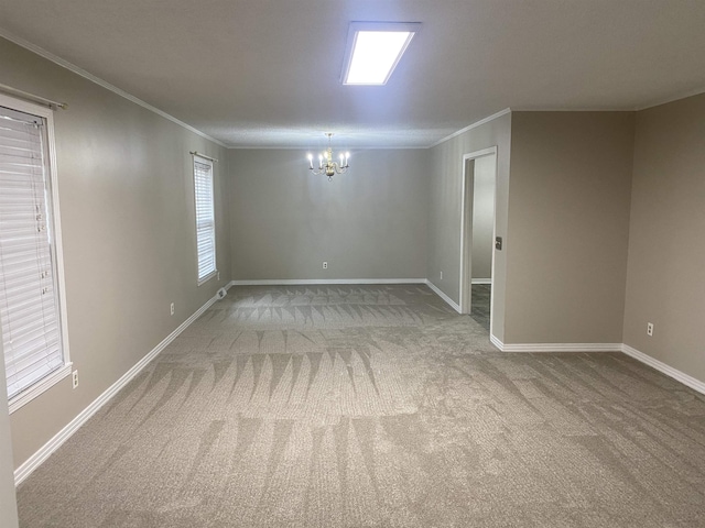 empty room featuring carpet, a notable chandelier, and crown molding