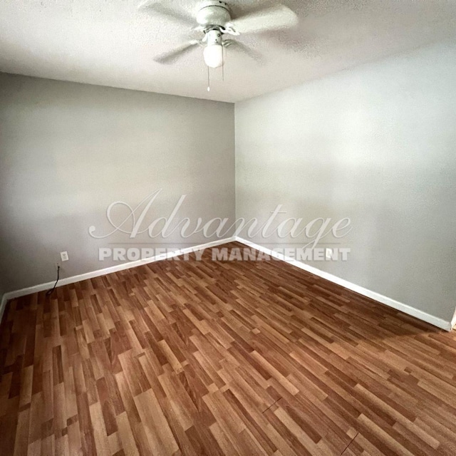 spare room with a textured ceiling, ceiling fan, and dark hardwood / wood-style flooring