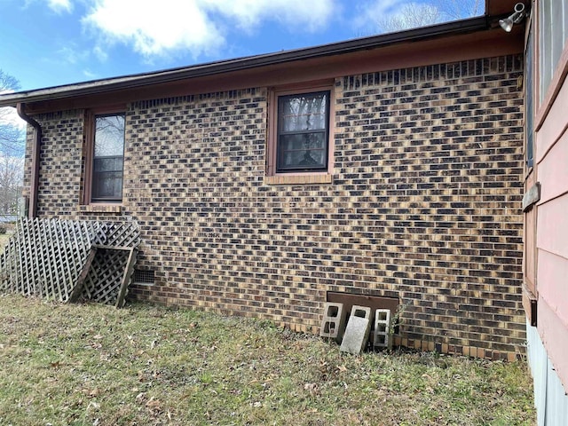 view of side of home with a yard