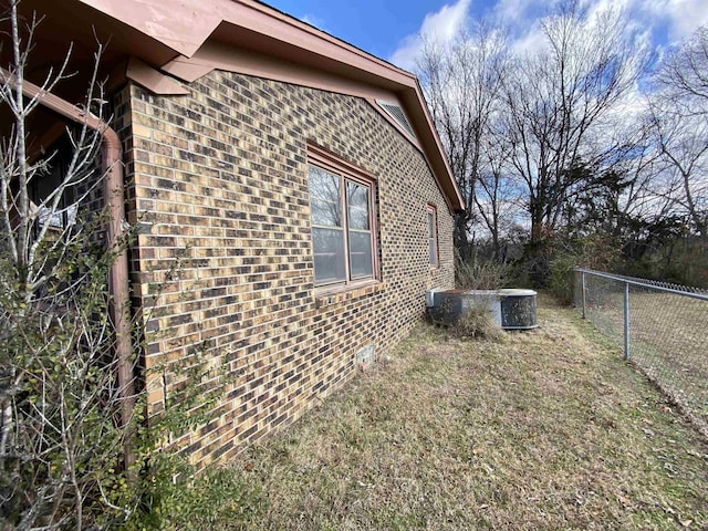 view of side of property with a lawn