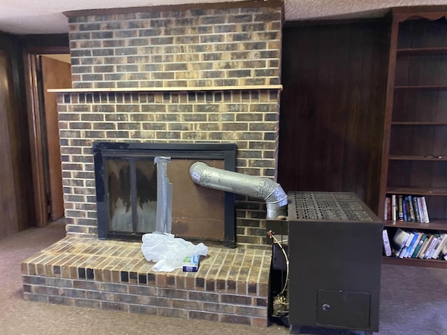 room details with a textured ceiling, carpet, a fireplace, and wooden walls