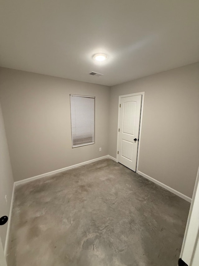 unfurnished room featuring concrete floors