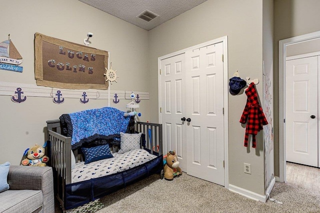 interior space with a textured ceiling and carpet flooring