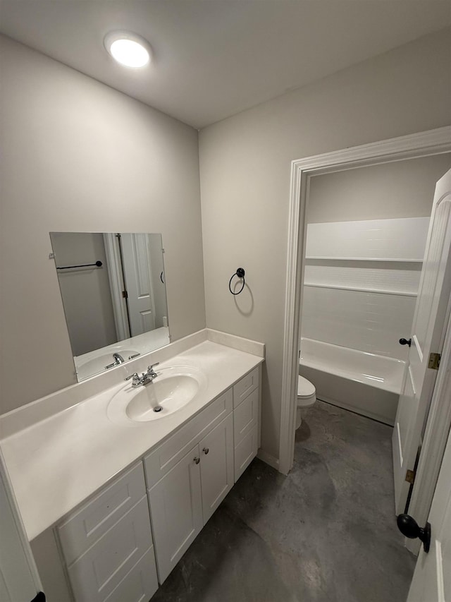 bathroom with vanity, concrete floors, and toilet