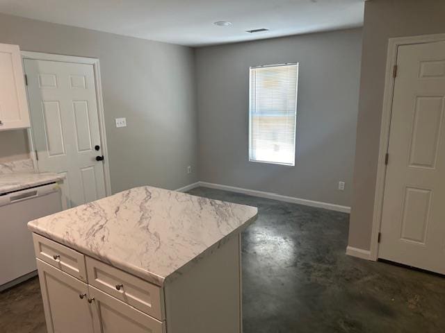 kitchen with white cabinets, dishwasher, and a kitchen island