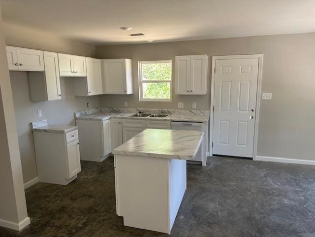 kitchen with sink, white cabinetry, dishwasher, and a kitchen island