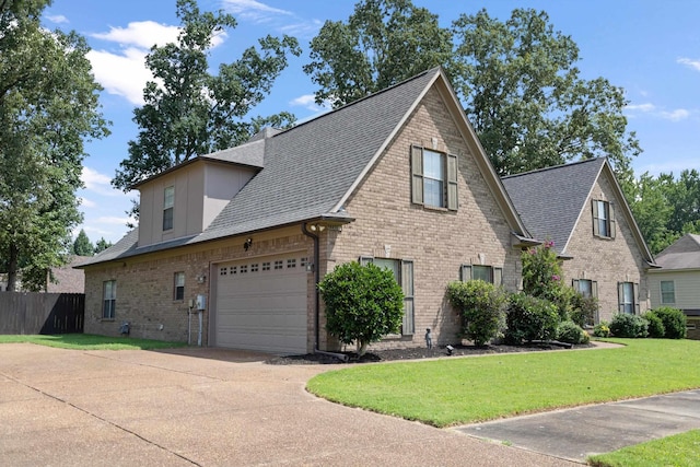 view of front facade with a front yard and a garage