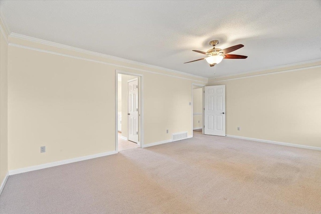 carpeted empty room featuring ceiling fan, ornamental molding, and a textured ceiling