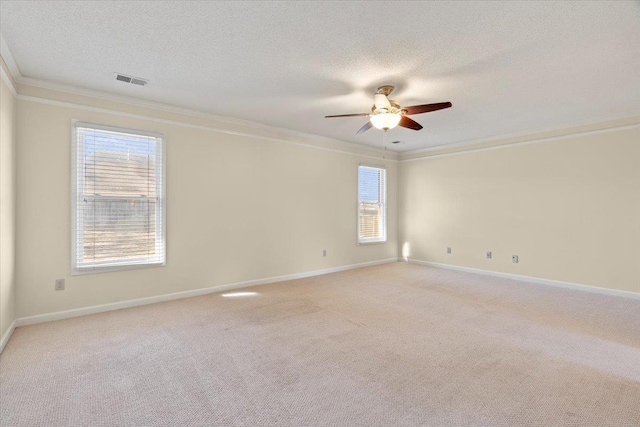 unfurnished room featuring light carpet, ceiling fan, ornamental molding, and a textured ceiling