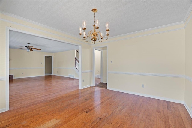 unfurnished room with ceiling fan with notable chandelier, wood-type flooring, ornamental molding, and a textured ceiling