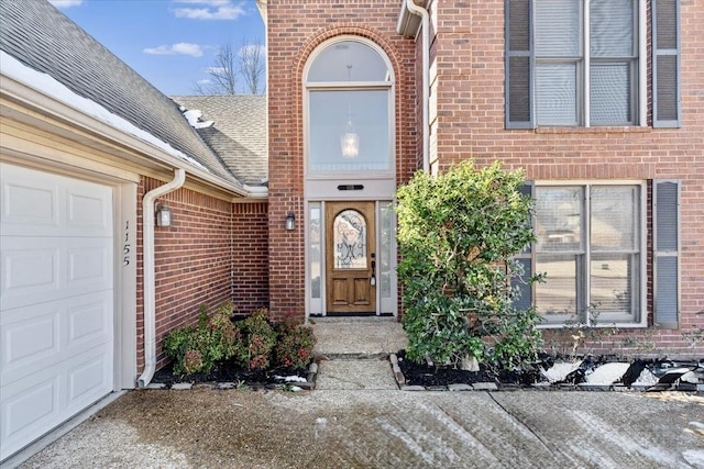 view of exterior entry with a garage