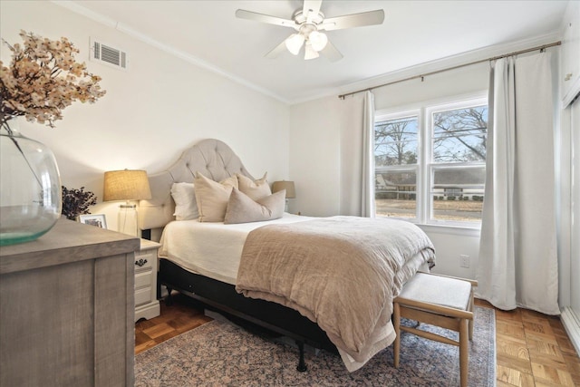 bedroom featuring ceiling fan, dark parquet floors, and crown molding