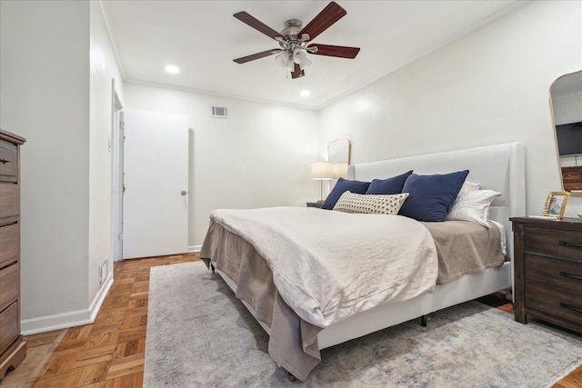 bedroom featuring ceiling fan, crown molding, and light parquet flooring