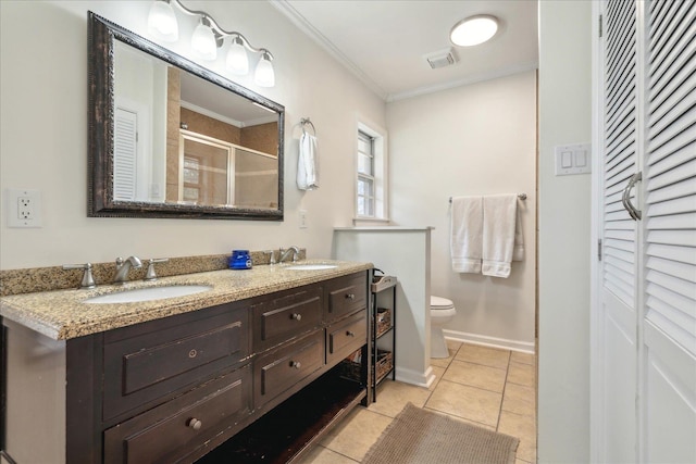 bathroom with toilet, a shower with door, tile patterned floors, crown molding, and vanity