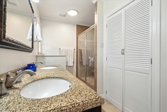 bathroom featuring walk in shower, ornamental molding, vanity, and tile patterned flooring