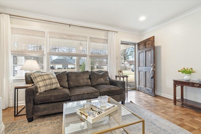 living room with light parquet floors, a wealth of natural light, and crown molding