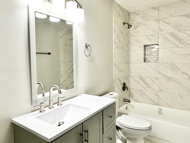 full bathroom featuring tiled shower / bath combo, vanity, and toilet