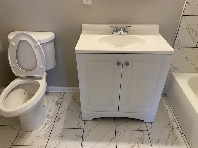 bathroom with toilet, vanity, and a bathing tub