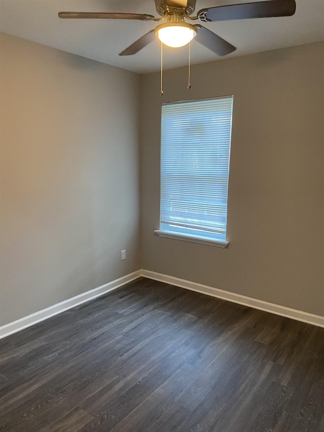 empty room with ceiling fan and dark hardwood / wood-style floors