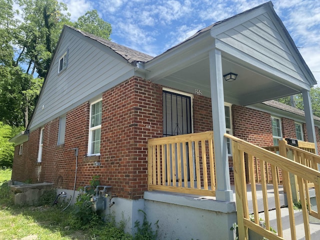 view of side of home with covered porch