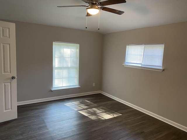 empty room featuring dark wood-type flooring and ceiling fan