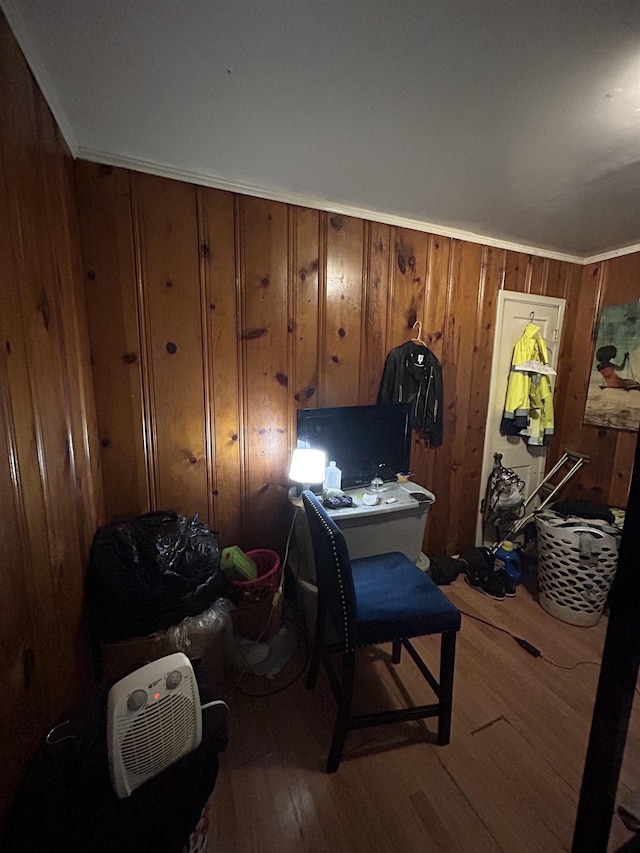 office featuring hardwood / wood-style flooring, ornamental molding, and wooden walls