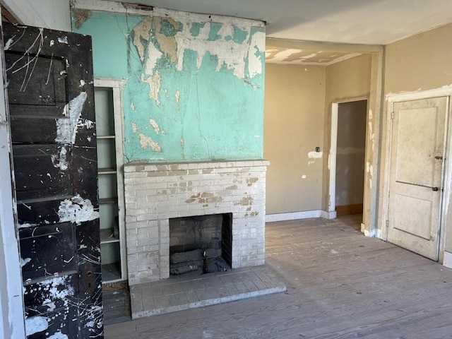 unfurnished living room with a brick fireplace