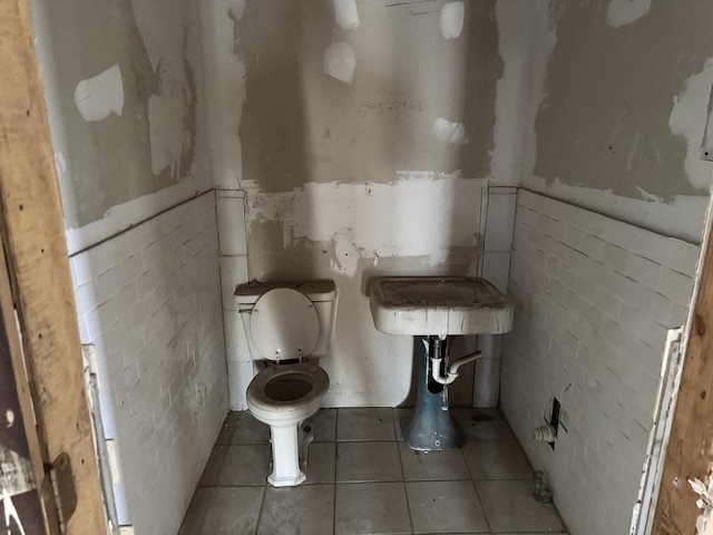 bathroom featuring toilet and tile patterned flooring