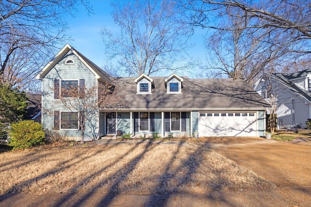 view of front of property featuring a front lawn and a garage