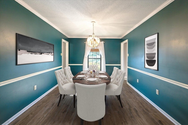 dining space with a textured ceiling, an inviting chandelier, ornamental molding, and dark hardwood / wood-style floors