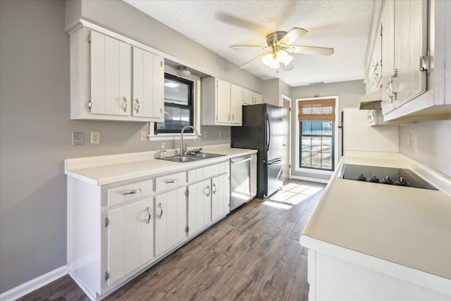 kitchen featuring dark hardwood / wood-style floors, a textured ceiling, black appliances, white cabinets, and sink