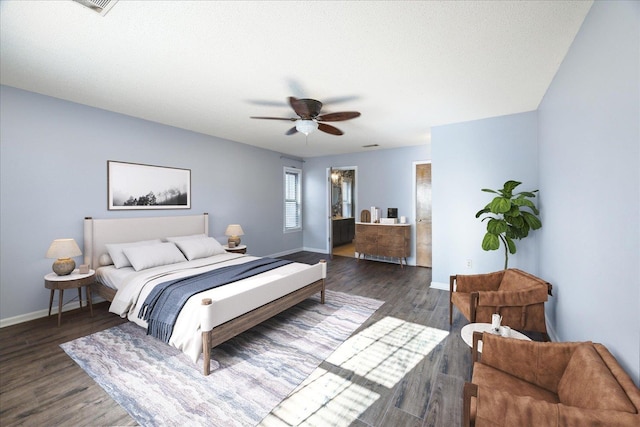 bedroom featuring ceiling fan, dark hardwood / wood-style floors, connected bathroom, and a textured ceiling