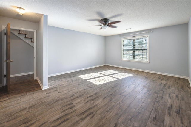 unfurnished room featuring a textured ceiling, ceiling fan, and dark hardwood / wood-style floors