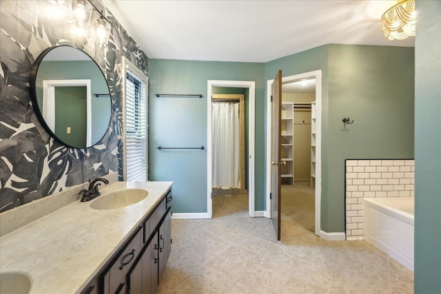 bathroom featuring a washtub and vanity