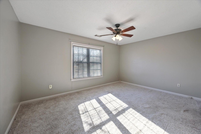 carpeted spare room featuring a textured ceiling and ceiling fan