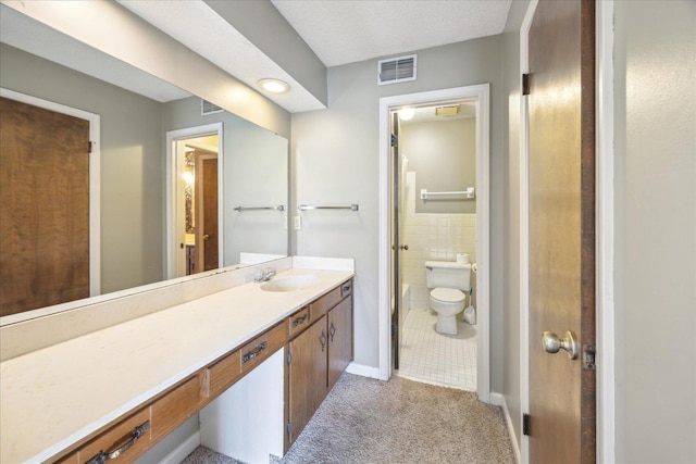 bathroom featuring toilet, a textured ceiling, vanity, and tile walls